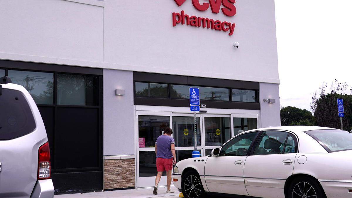 A customer walks into a CVS Pharmacy store on Aug. 3, 2021, in Woburn, Massachusetts. State-licensed pharmacists can now prescribe Paxlovid, alongside doctors, as a COVID-19 treatment for people who are eligible to receive it, the FDA says.