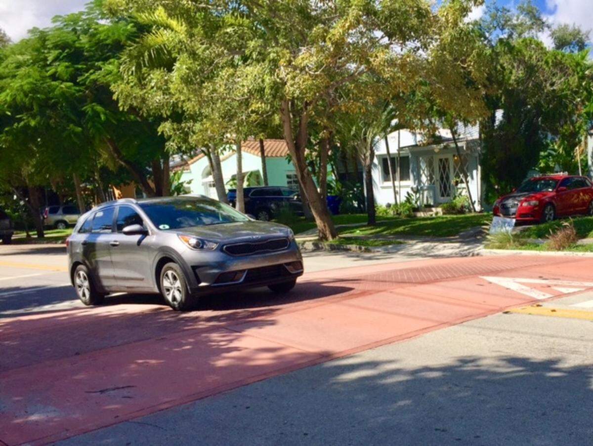 A car eases over a speed hump in Miami’s Upper East Side neighborhood.