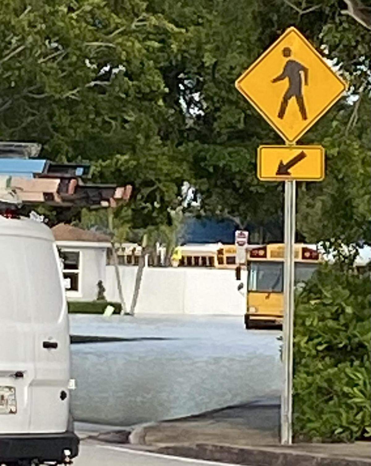 A school bus is parked in a flooded neighborhood road near Southwest 212th Avenue and Old Cutler Road Tuesday, Jan. 9, 2024. A water main in the area broke, causing heavy traffic delays in the area during morning rush hour traffic.