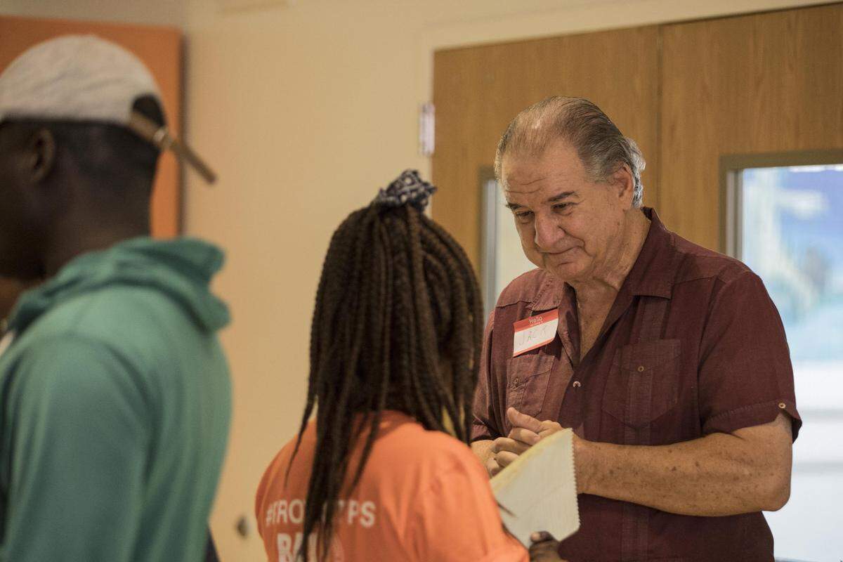 Jack Lieberman speaks to an activist after a press conference about the state of Temporary Protected Status for Haitians at the Caribbean Marketplace in Little Haiti on June 22, 2018.