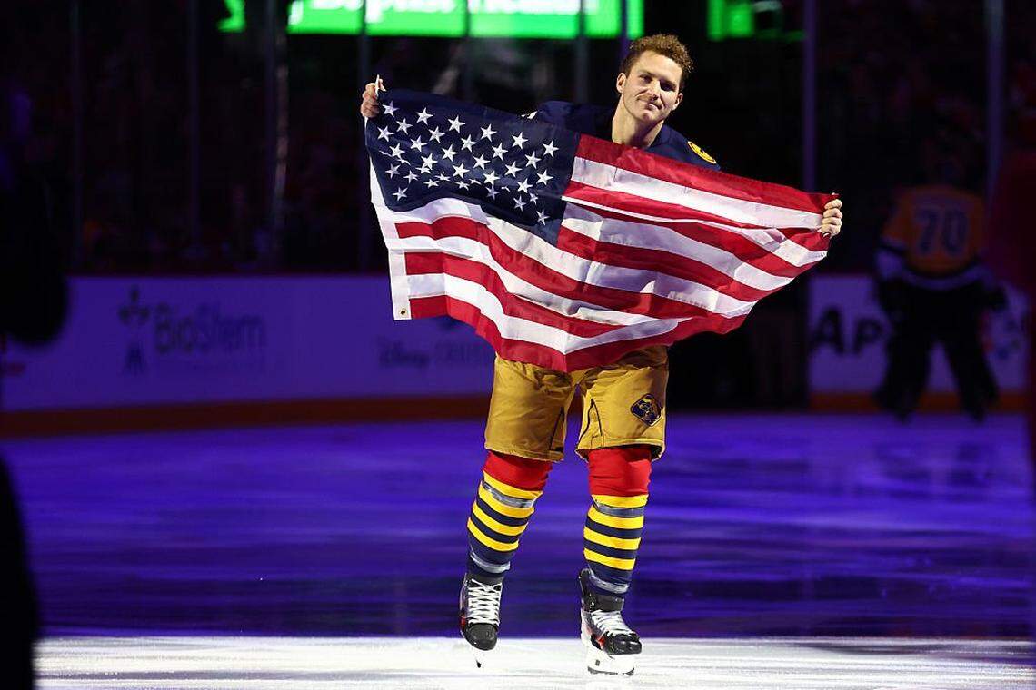 SUNRISE, FLORIDA - FEBRUARY 04: Matthew Tkachuk #19 of the Florida Panthers skates with the American flag prior to a game against the Boston Bruins at Amerant Bank Arena on February 04, 2026 in Sunrise, Florida. (Photo by Megan Briggs/Getty Images)