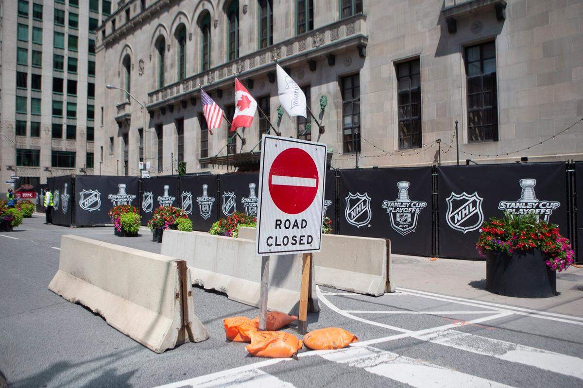 A section of the street outside Toronto’s Royal York hotel is closed off as NHL teams arrive at the “bubble” ahead of the return of the league’s season following a disruption due to the COVID-19 pandemic, in Toronto, Sunday, July 26, 2020. (Chris Young/The Canadian Press via AP)