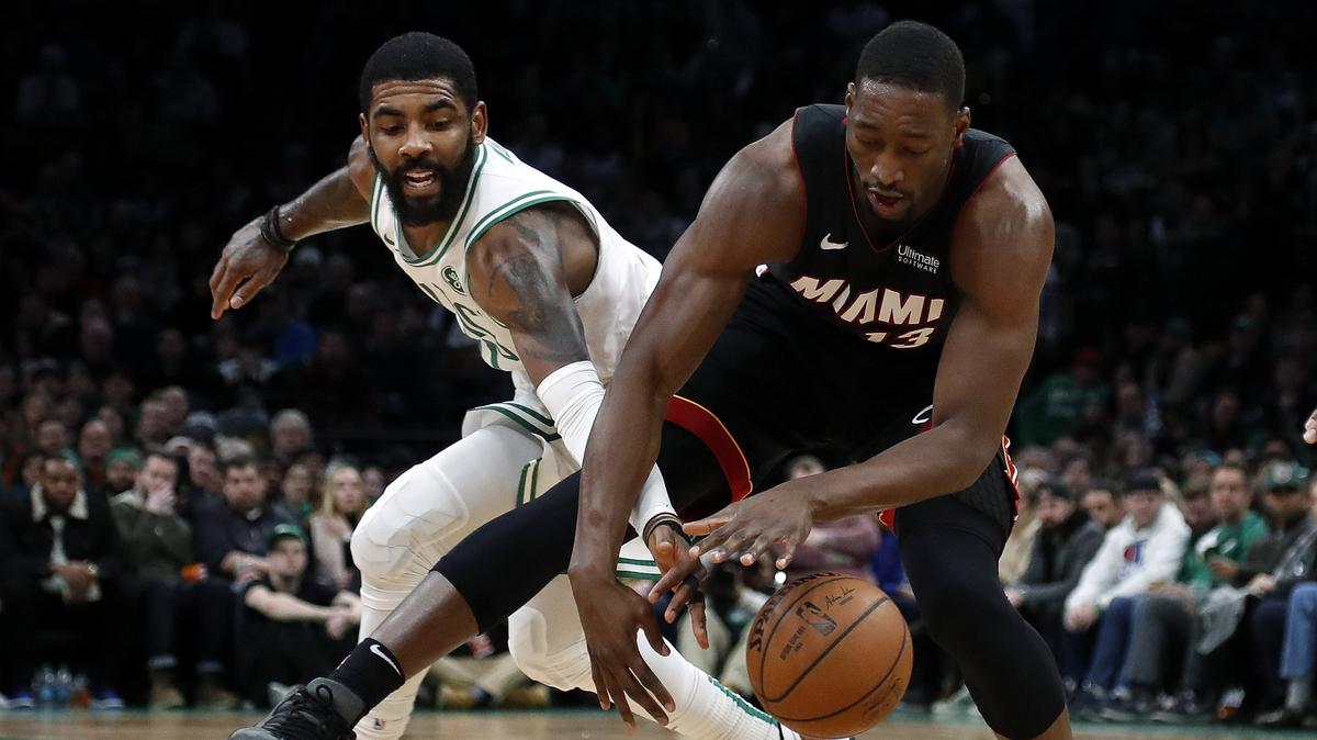 Boston Celtics’ Kyrie Irving, left, reaches in to knock the ball away from Miami Heat’s Bam Adebayo during the second half of an NBA basketball game Monday, Jan. 21, 2019, in Boston. (AP Photo/Winslow Townson)