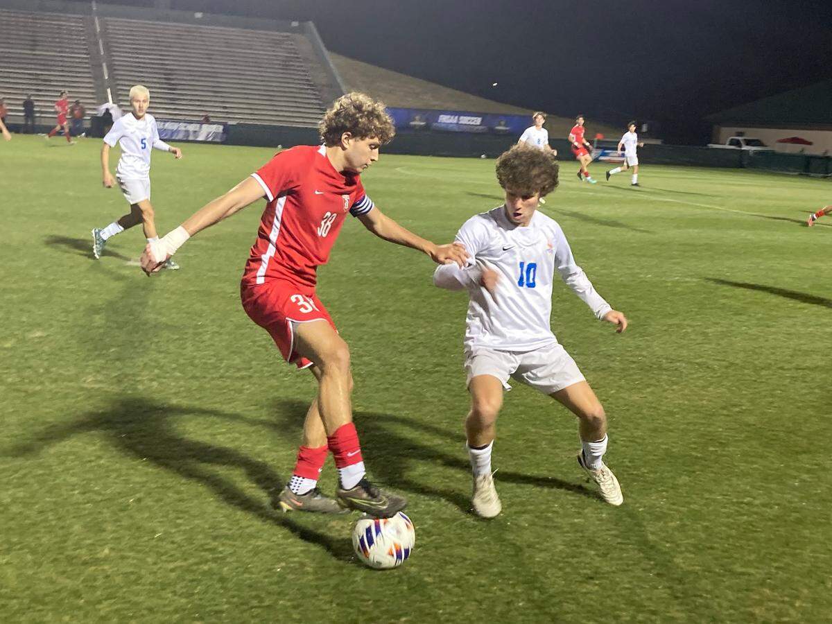 Doral Academy’s Rafael Schneider handles the ball while matched up against West Orange’s Zack Grauer Thursday night’s Class 7A state semifinal at Spec Martin Stadium in DeLand.