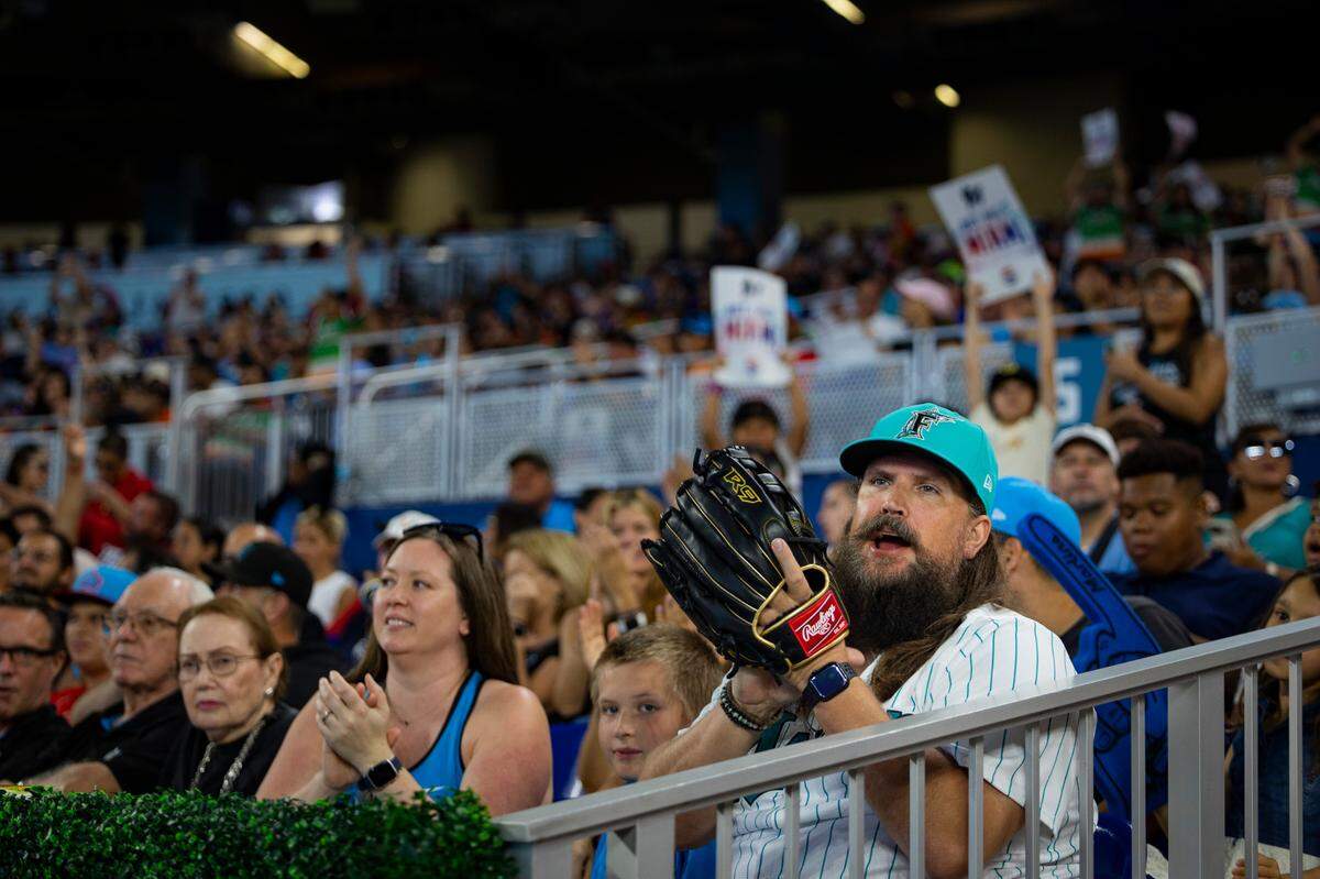Fans cheer for a slide and catch by Miami Marlins left fielder Bryan De La Cruz (14) during the sixth inning of a baseball game on Sunday, Sept. 24, 2023, at loanDepot Park in Miami.