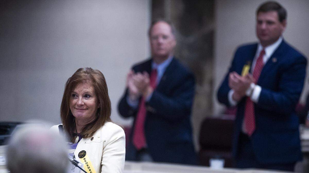 Republican Rep. Terri Collins gets a standing ovation after her near-total ban on abortion bill passes the Alabama House.