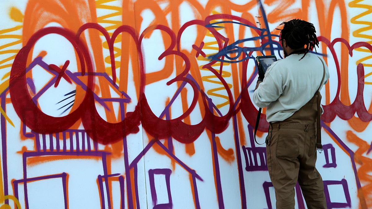 Artist Brandan Bmike Odums paints a portrait Mural of Dana Albert “D. A.” Dorsey (1872-1940), a businessman, banker, and philanthropist who came to the Miami area around 1896. He became one of the first African-American millionaires in Florida. He is one of a group of artists displayed at the Afrofuture fair at The Urban Space in Overtown during Art Basel Miami Beach, Dec. 5-9, 2018.