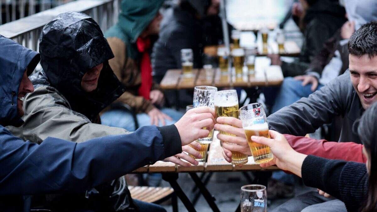 Friends toast each other as they drink a beer on a terrace in Brussels, on May 8, 2021, as the Belgium government eased the restrictions put in place to curb the spread of the coronavirus Covid-19.