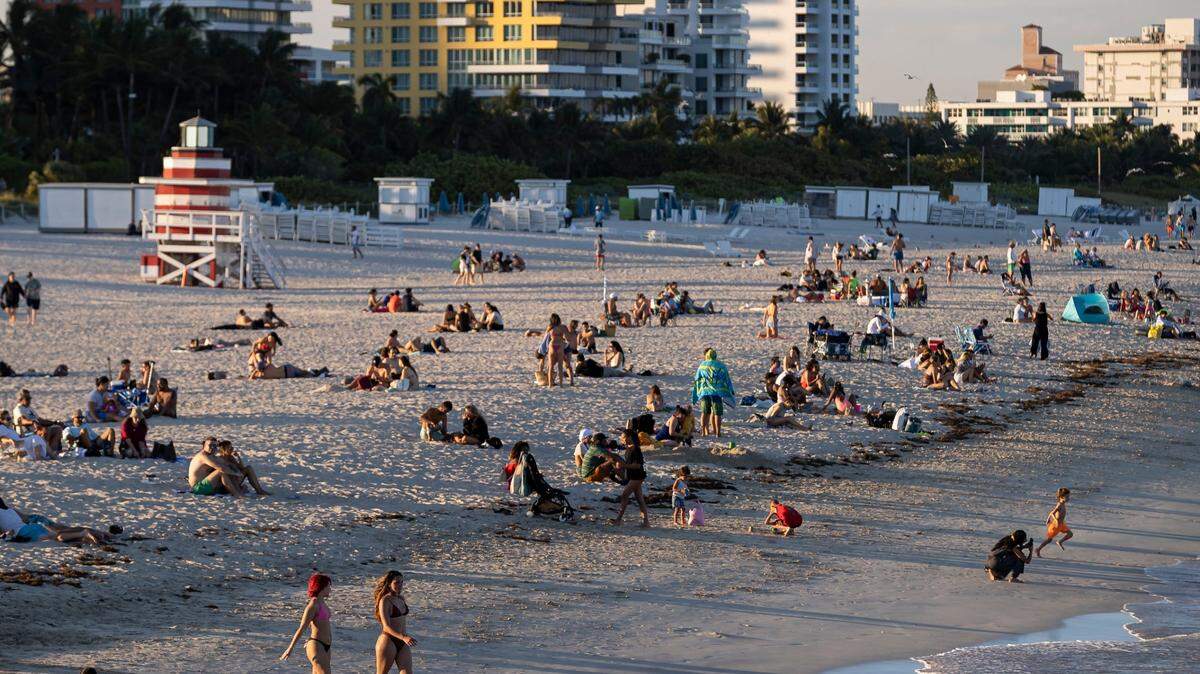 People visit the beach at South Pointe on Monday, Feb. 27, 2023, in Miami Beach, Fla. Forecasters expect temperatures to be around 90 degrees this week across South Florida.