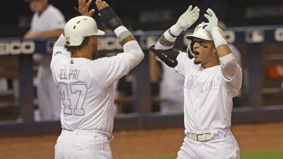Miami Marlins second baseman Isan Diaz (1) is congratulated by left fielder Harold Ramirez (47) after hitting a three run home run during the third inning of a Major League Baseball game at Marlins Park in Miami on Friday, August 23, 2019.