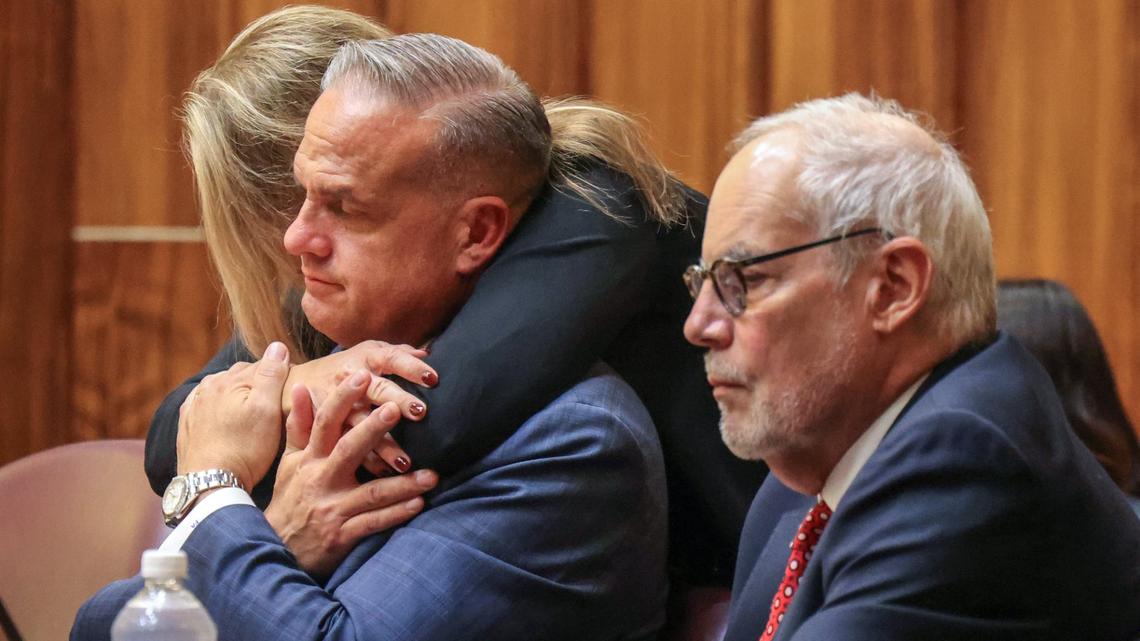 Frank Artiles, center, gets a hug of support from his wife Aimee Artiles, before the verdict of guilty on three felony counts related to $44,000 in payments he made to Alex Rodriguez, was read by the judge as Jose Quiñon, right, sits by his side as the six-member jury deliberated for several hours on Monday, September 30, 2024, inside Courtroom 4-1 at the Richard E. Gerstein Justice Building on Monday, September 30, 2024, in Miami, Florida.
