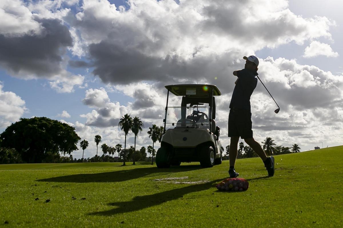 Alejandro La Corte, 33, golfs while visiting the International Links Melreese Country Club on Tuesday, shortly before Miami city officials closed the golf course.