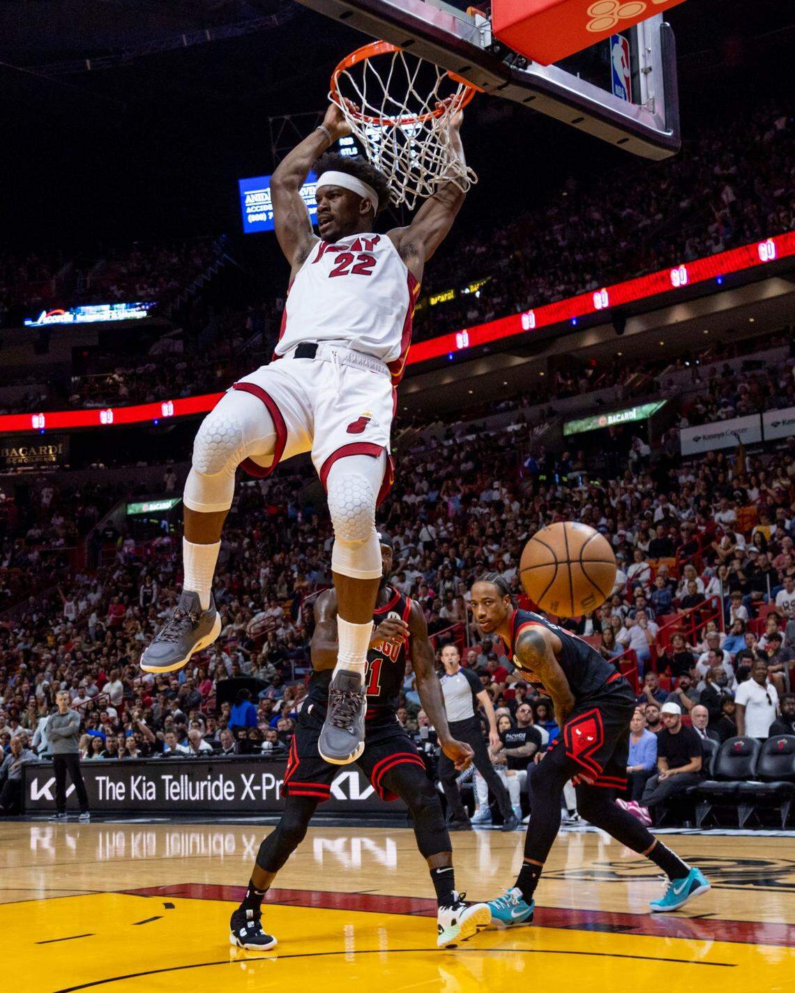 Miami Heat forward Jimmy Butler (22) dunks the ball as Chicago Bulls players look on during the fourth quarter of an NBA play-in tournament game at Kaseya Center in Downtown Miami, Florida, on Friday, April 14, 2023.