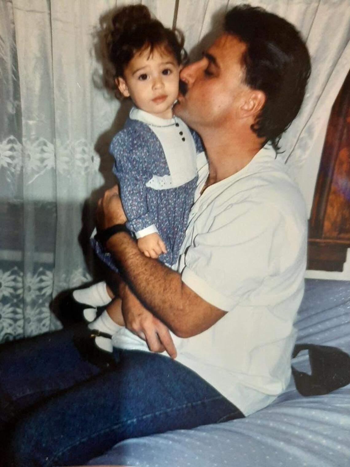 Heriberto Delvalle poses with his daughter in the early 90s.