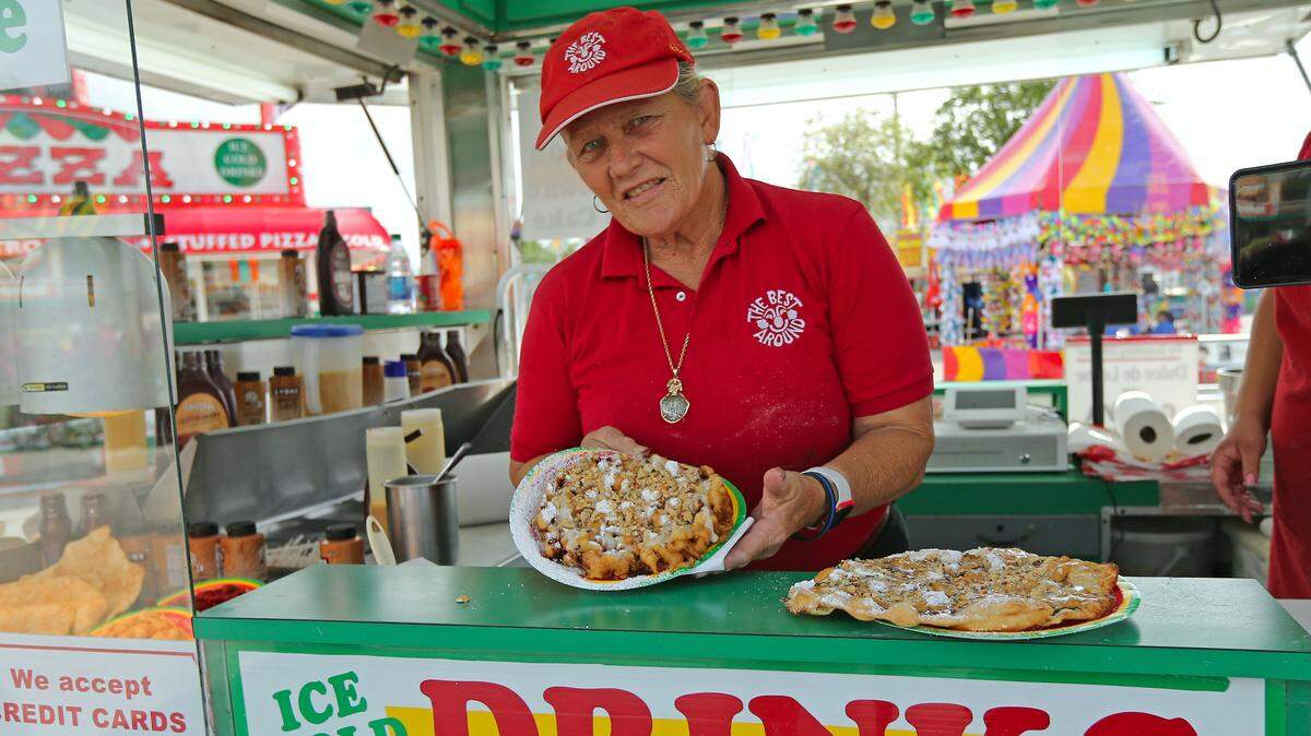 Jane Harris , aka “Mama Jane,” shows off her famous funnel cake at the youth fair in 2019. Get your fix after you ride the scary rides for maximum enjoyment.