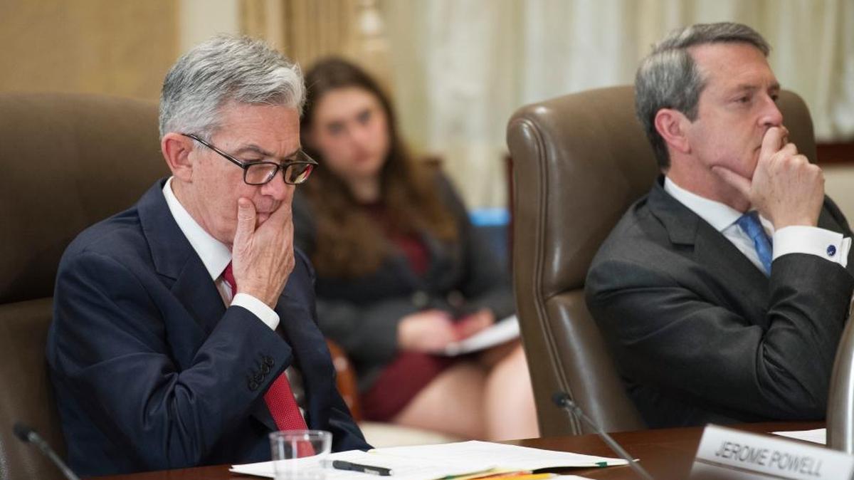 Federal Reserve Board Chairman Jerome Powell, left, and Vice Chair Randal Quarles listen during an open meeting in Washington on June 14. If the Fed sticks to its schedule, it will shed more than $420 billion of the government bonds and mortgage-backed bonds it bought after the Great Recession.