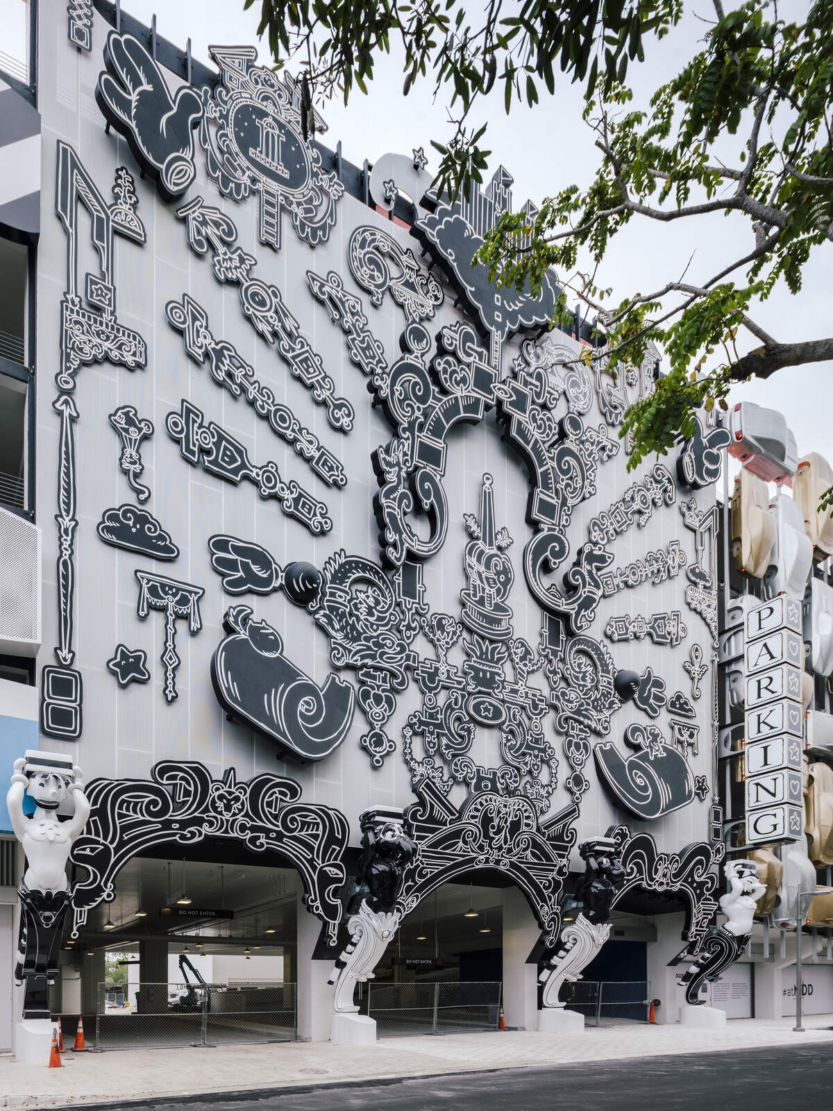 The Museum Garage's main entrance facade, "Serious Play," by French artist Nicolas Buffe, combines Rococo arches and architectural fragments to video-game elements and Japanese anime.