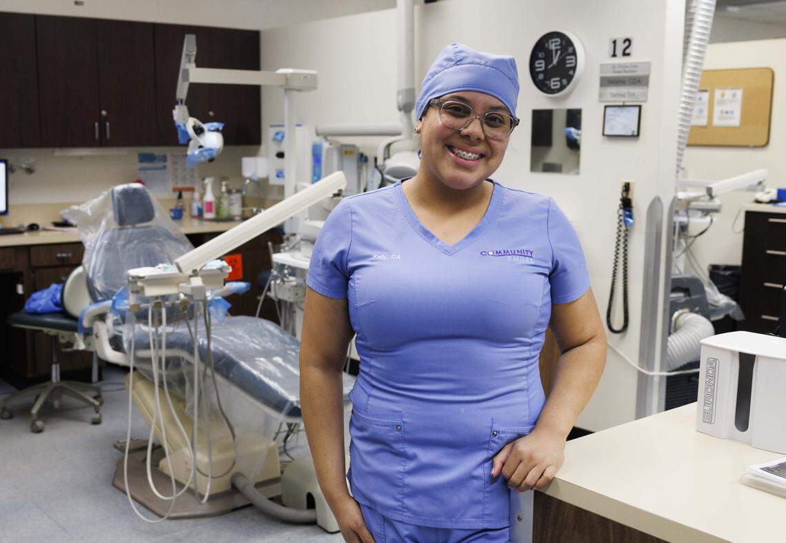 Kelly Garcia, sterilization tech and former student, poses during the day in the community dentist office on Tuesday, Oct. 21, 2025, at Lindsey Hopkins Technical College in downtown Miami. Now fully time employed with Community Smiles, Kelly is also working towards a degree at Miami Dade College. “To help my community where was very impacting even for my parents, and once I started bringing them here they got help,” said Kelly.