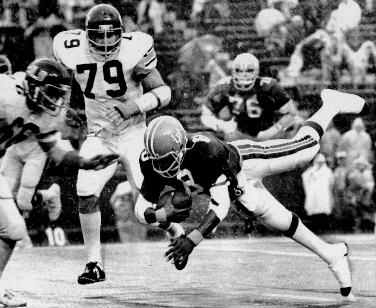 University of Florida quarterback Don Gaffney runs for a first down in the rain against the University of Miami.