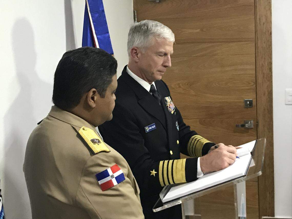 Navy Adm. Craig Faller, head of U.S. Southern Command, signs a book in Santo Domingo, Dominican Republic, on Friday, Nov. 8, 2019, after touring its Emergency Operations Center.