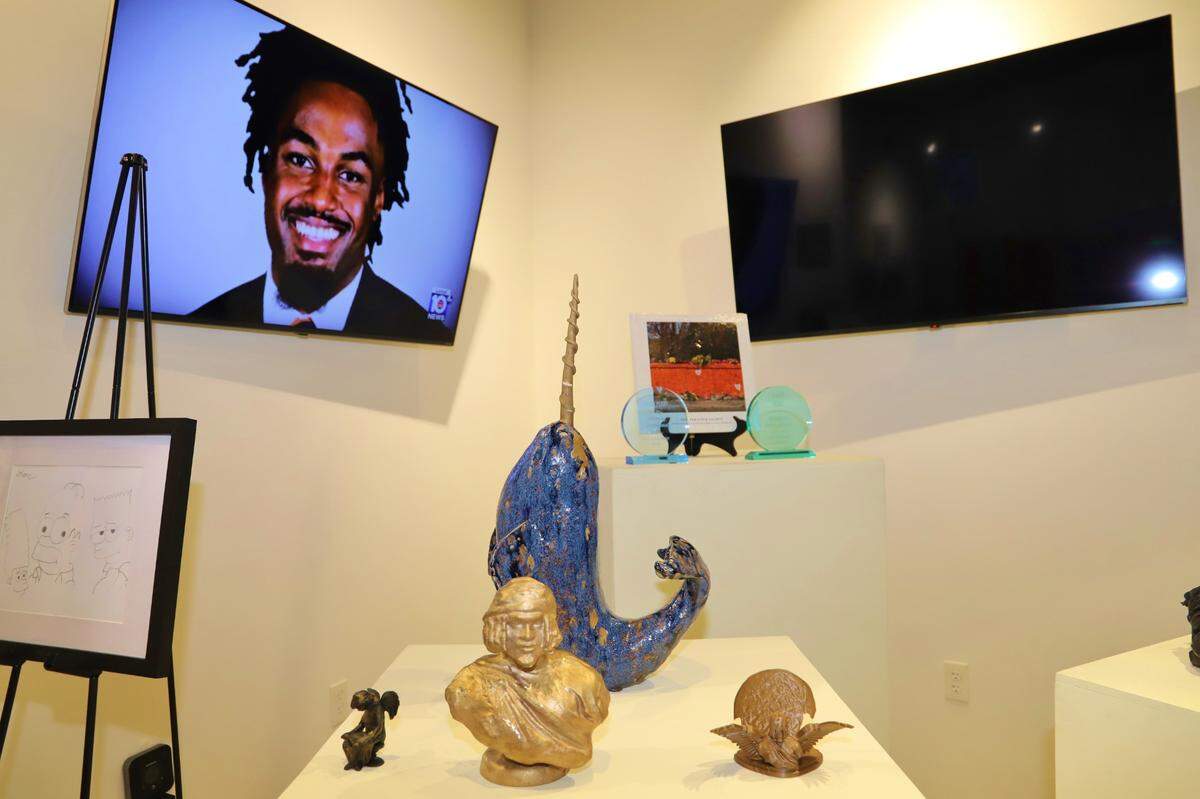 Several of D’Sean Perry’s art pieces featured in the Love-Art-Football Exhibit. The exhibit, which honors the life of the late UVA football player and Richmond Heights native, is currently on display at the South Dade Black History Center until Nov. 14.