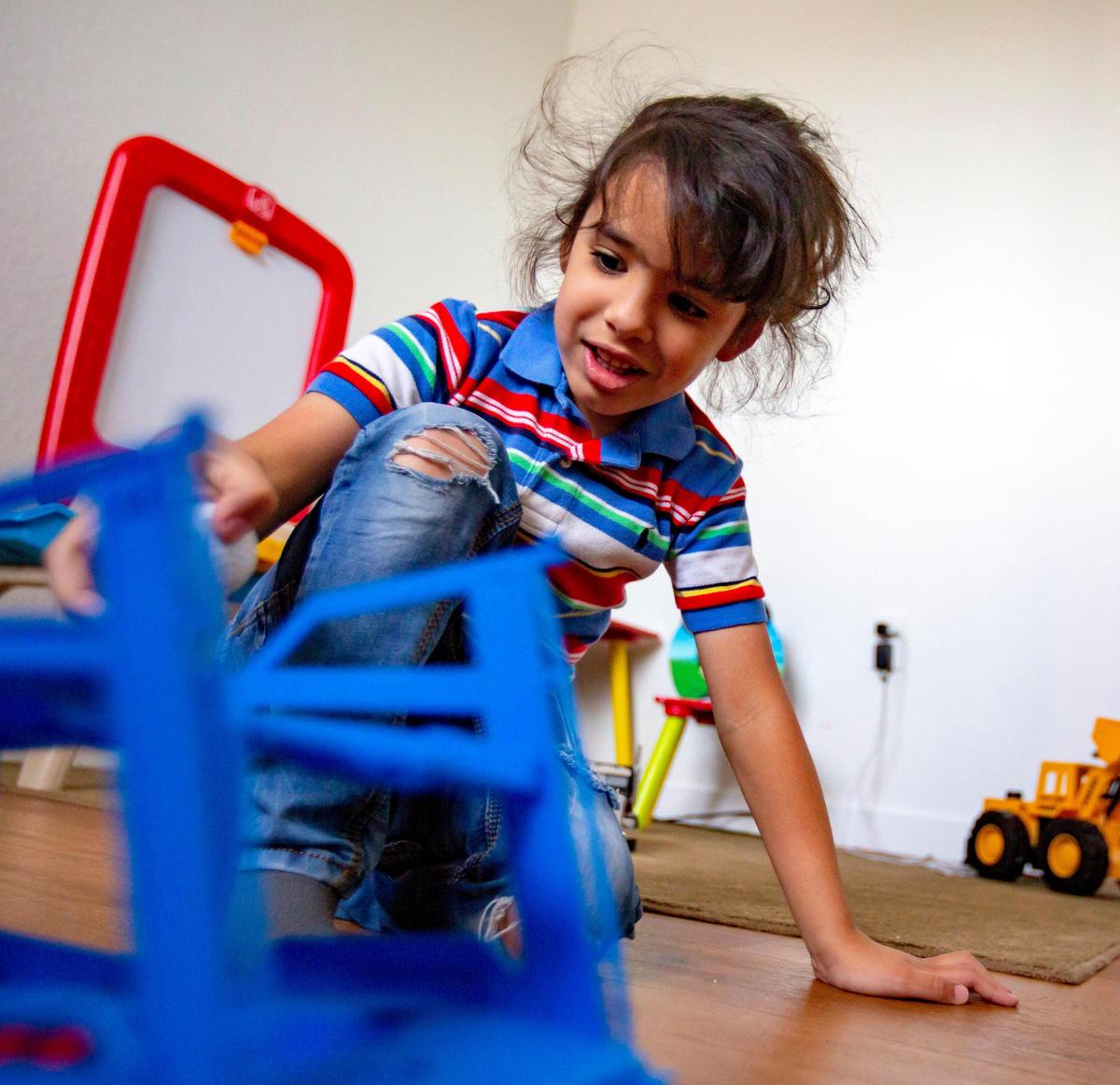 David Silva Jr., 4, who is on the autism spectrum, plays in his room at his parents’ Miami apartment. After his special needs daycare facility closed due to the coronavirus pandemic, his mother quit her job to care for him daily.