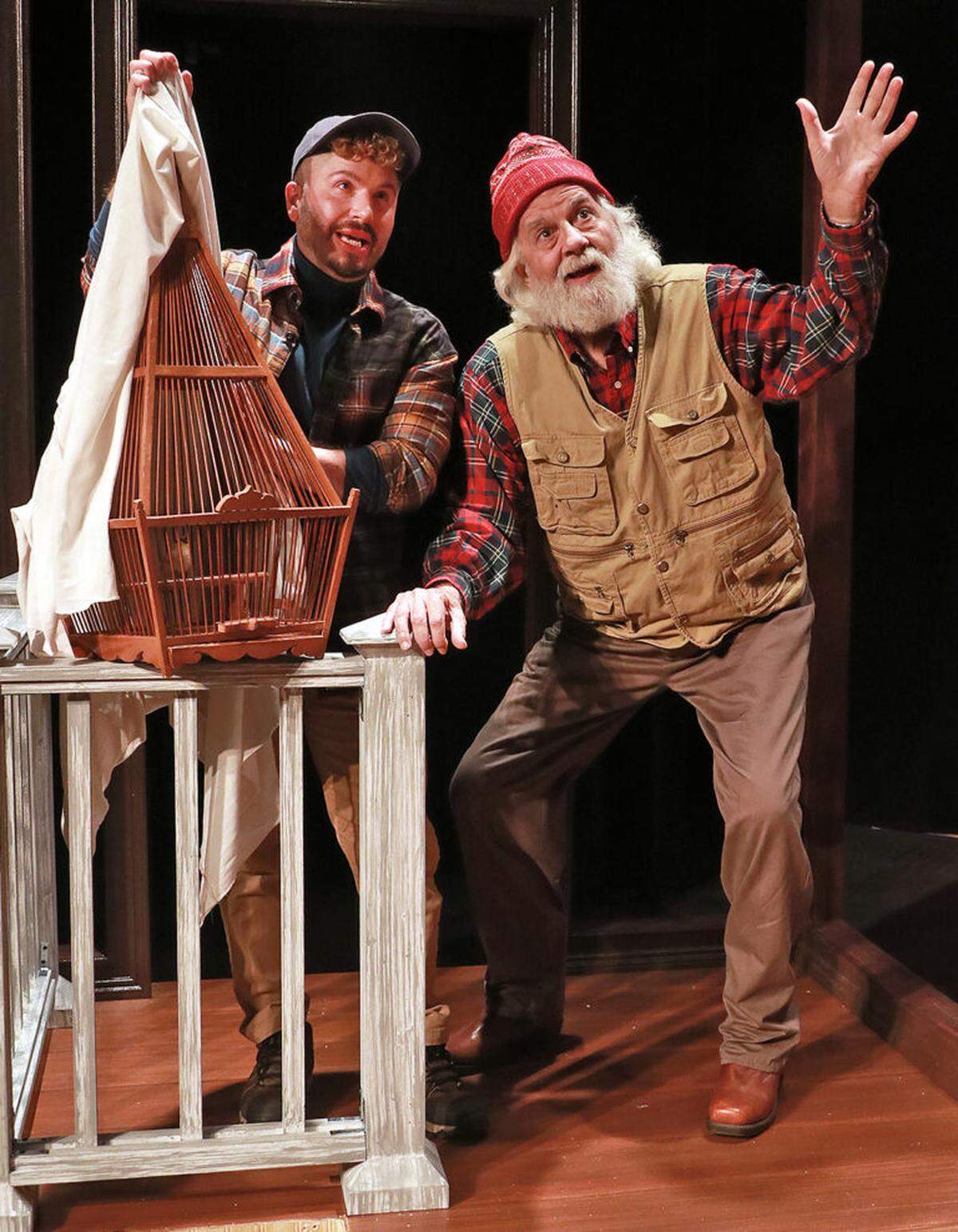 From left, Conor Walton as Blake and Michael Gioia as Maynard watch a red Cardinal fly away in “Sweet Goats and Blueberry Señoritas,” an Actors’ Playhouse production at the Miracle Theatre.