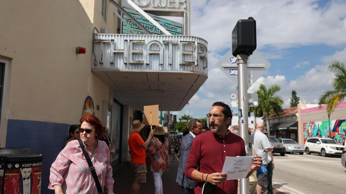 Back in 2022, Gabriel Rhenals, right, held a sign during a protest in Little Havana to keep the Tower Theater in the hands of Miami Dade College.