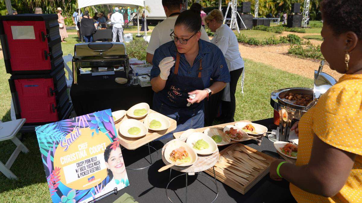 A vendor offers a pork belly dish at last year’s Creole Food Festival, held at the Ancient Spanish Monastery in North Miami Beach. This year the event, which features food and music, will be held on Lincoln Road in Miami Beach.