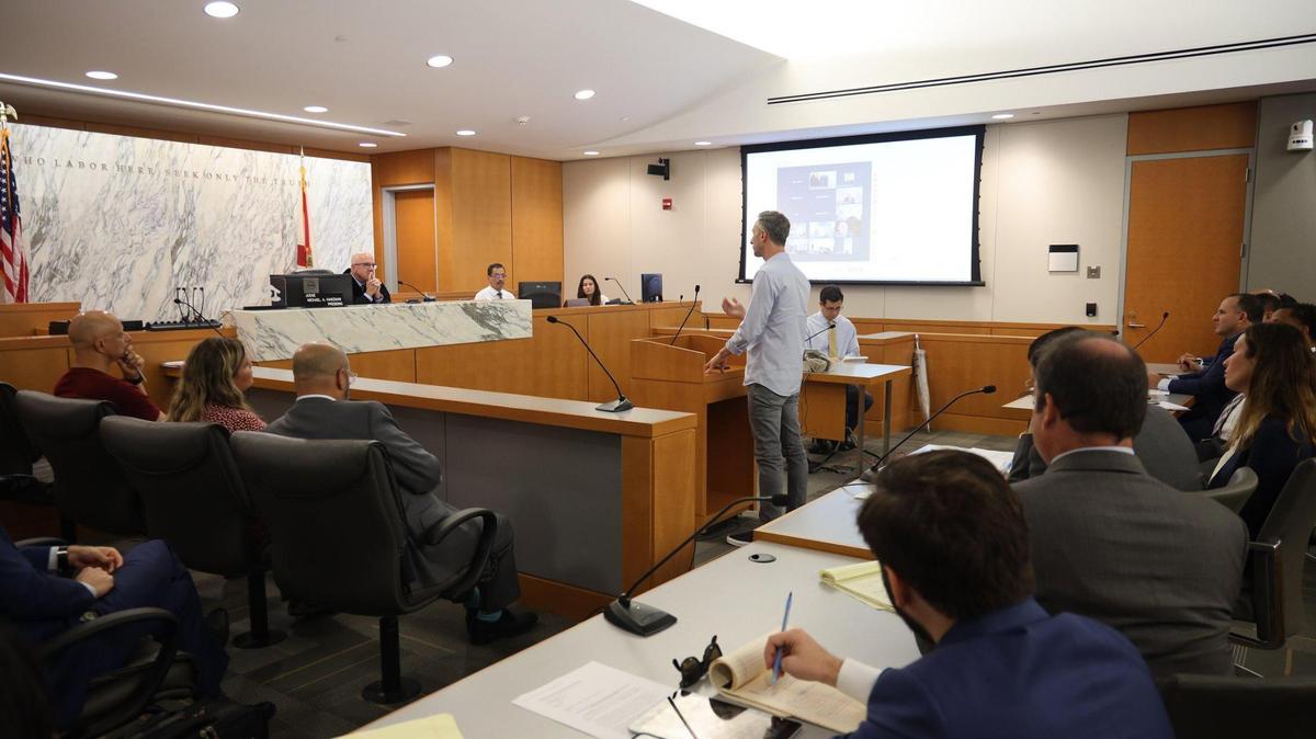 Oren Cytrynbaum, center, whose family owned two units in Champlain Towers South, speaks to Judge Michael Hanzman about his wishes for the future site. The Miami-Dade circuit judge presided over the status hearing for the Surfside condo collapse litigation with residents and their lawyers, along with the condo association’s legal representatives.