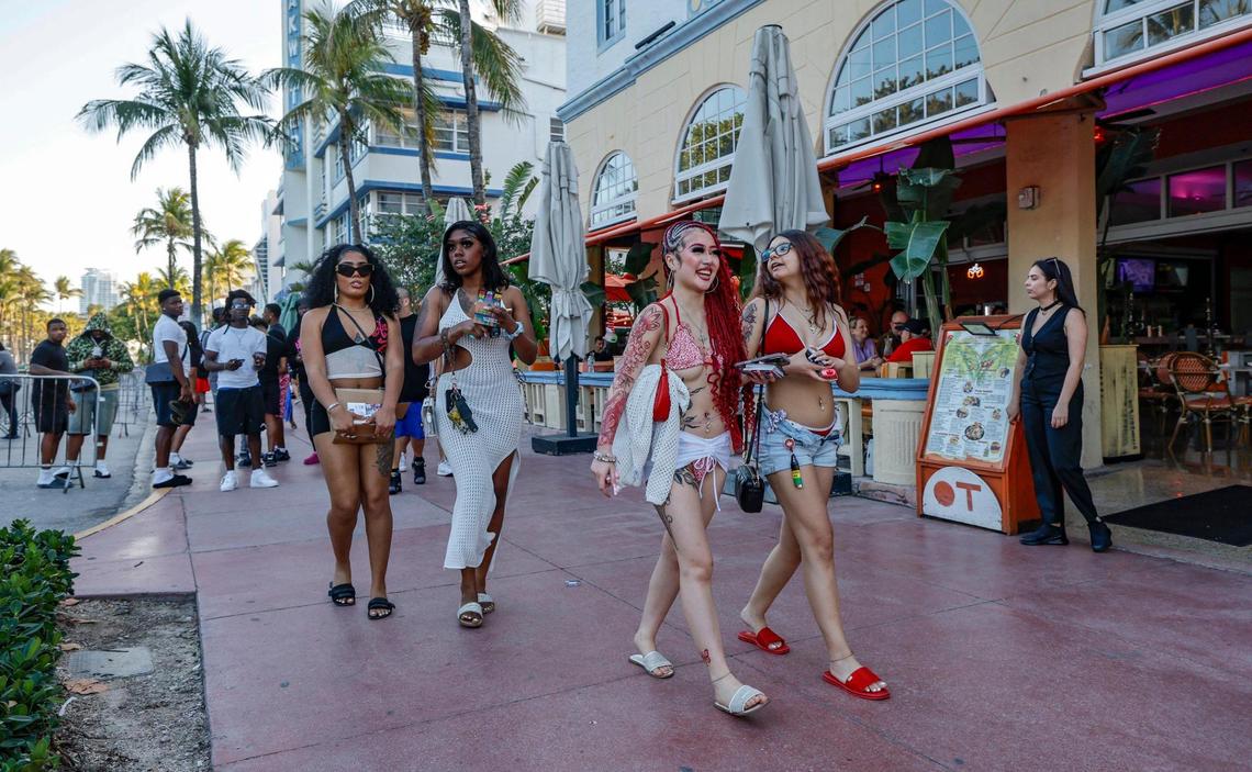 Spring breakers from Atlanta, Krystal Nguyen and Jessica Chavez, at front right, walk along Ocean Drive along Ocean Drive, Miami Beach, Florida on Friday, March 14, 2025.