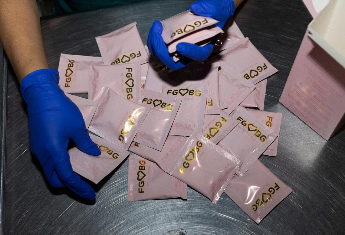 A worker packages FGBG Hair, Skin and Nail gummies in the PharmaCenter packing warehouse on Tuesday, March 19, 2024, in Davie, Florida.