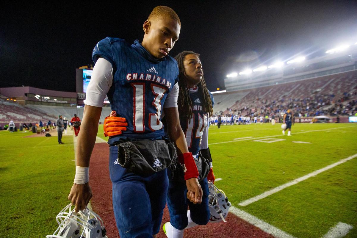 Chaminade-Madonna quarterback Jaylon Tolbert (13) is consoled by receiver British Mitchell Jr., af