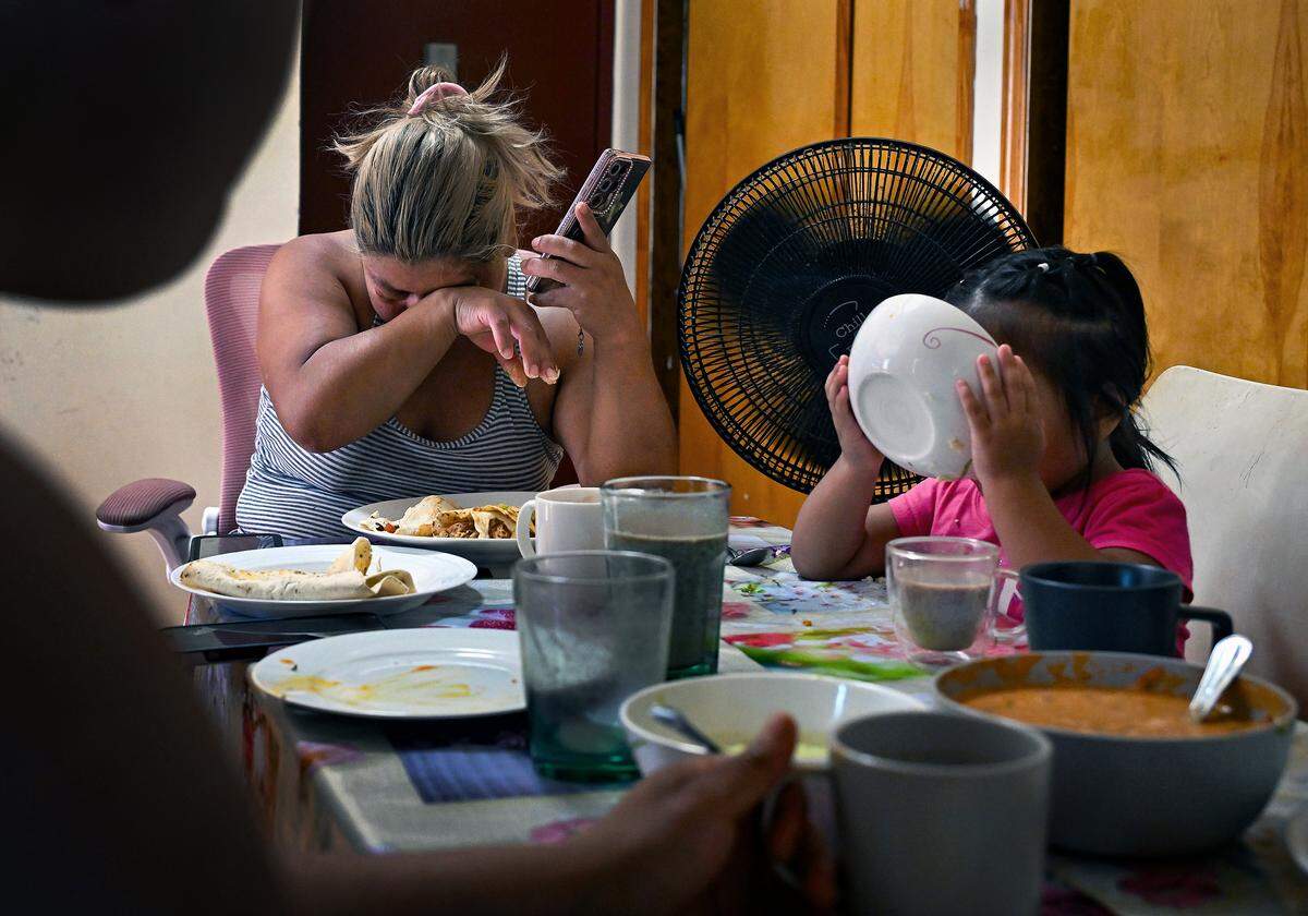 Anita breaks down in tears at the dinner table while talking to her husband Hermel, who is languishing in the limbo of detention, at her home in Brooklyn on Aug. 16, 2025. 