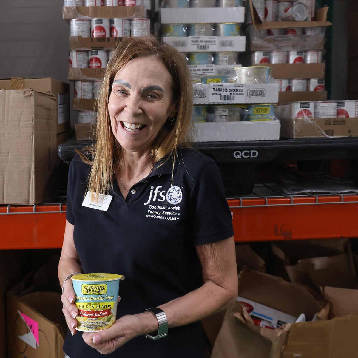 Volunteers coordinator Michelle Pines leads the assembly of food packages and their delivery to food insecure families during Passover at the Goodman Jewish Family Services food pantry.