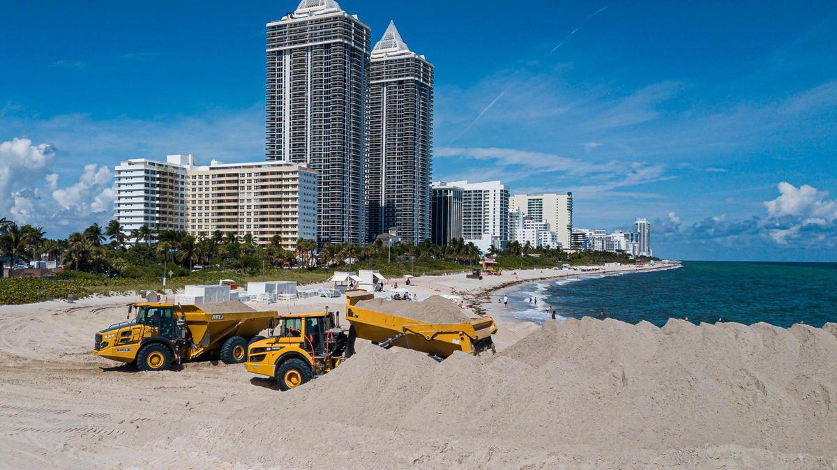 Trucks offload sand near Indian Beach Park in Miami Beach as part of a U.S. Army Corps of Engineers beach renourishment project on Oct. 12.