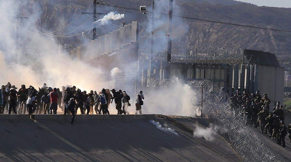 U.S. Customs and Border Protection officers fired tear gas upon migrants in Tijuana, Mexico, waiting out a drawn-out asylum process, when many of them rushed the fence between the two countries.