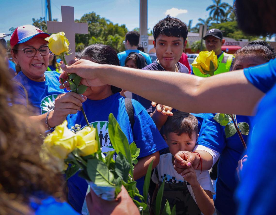 WeCount members line-up to receive yellow roses prior to marching in memory of plant nursery worker who have died due to extreme heat at Sacred Heart Catholic Church in Homestead, Florida on Sunday, April 27, 2025.