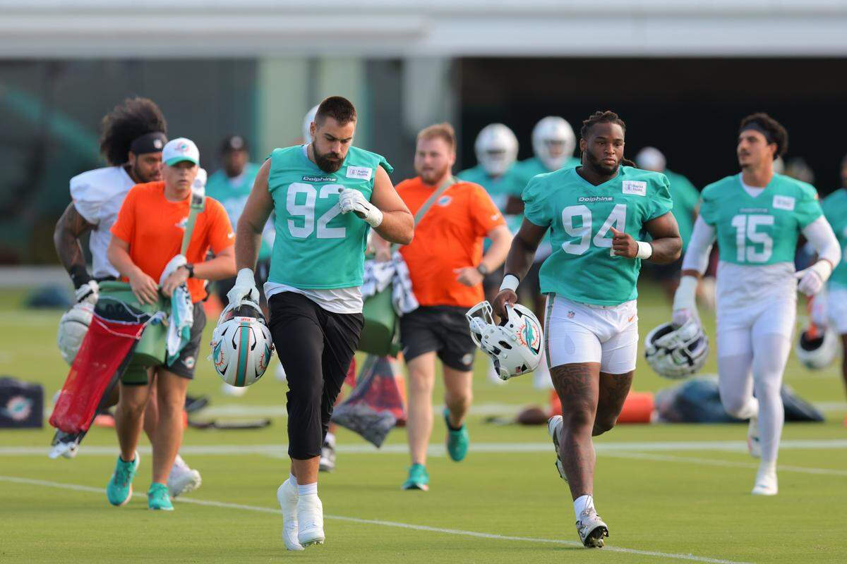 Miami Dolphins defensive tackle Zach Sieler (92) and defensive tackle Jordan Phillips (94) run on the field during training camp at Baptist Health Training Complex in Miami Gardens, Florida, Saturday, July 26, 2025.