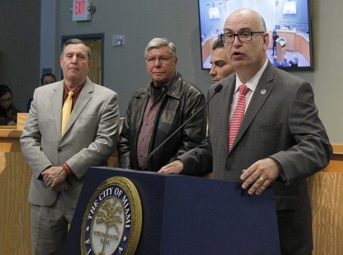 City of Miami Manager Emilio Gonzalez speaks at a press conference in January 2018. Standing with him, from left, are Joe Carollo, Manolo Reyes and Francis Suarez.