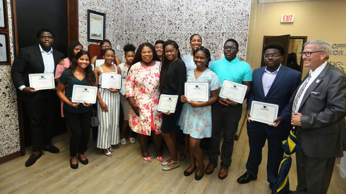 Representatives of the North Miami Educational Foundation awarded $3,000 scholarships to 13 North Miami students. From left: Rodrigue Bichotte, Ydreillina Jean Francois, Edna Pierre, Tashae Austin, Abraham Arróliga, Board Member Sophia Hall, Radjeanny Bouzi, Ashley Gil, Senator Daphne Campbell, Shama Torchon, Krystell Michel, Joshua Delva, Cedrick Joseph and Board Member Steven Moll.