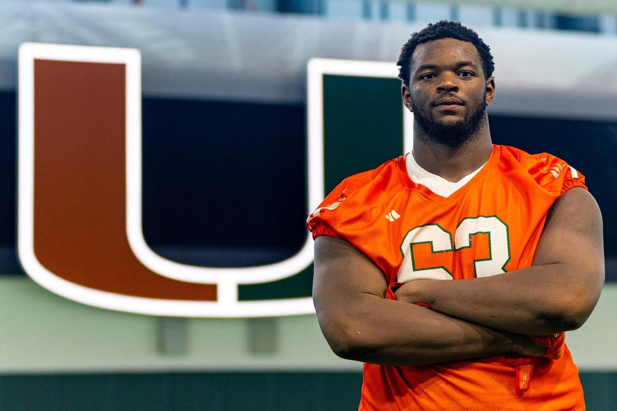 University of Miami offensive lineman Samson Okunlola (63) strikes a pose during media availability at UM’s Carol Soffer Indoor Practice Facility in Coral Gables, Florida, on Tuesday, August 22, 2023.