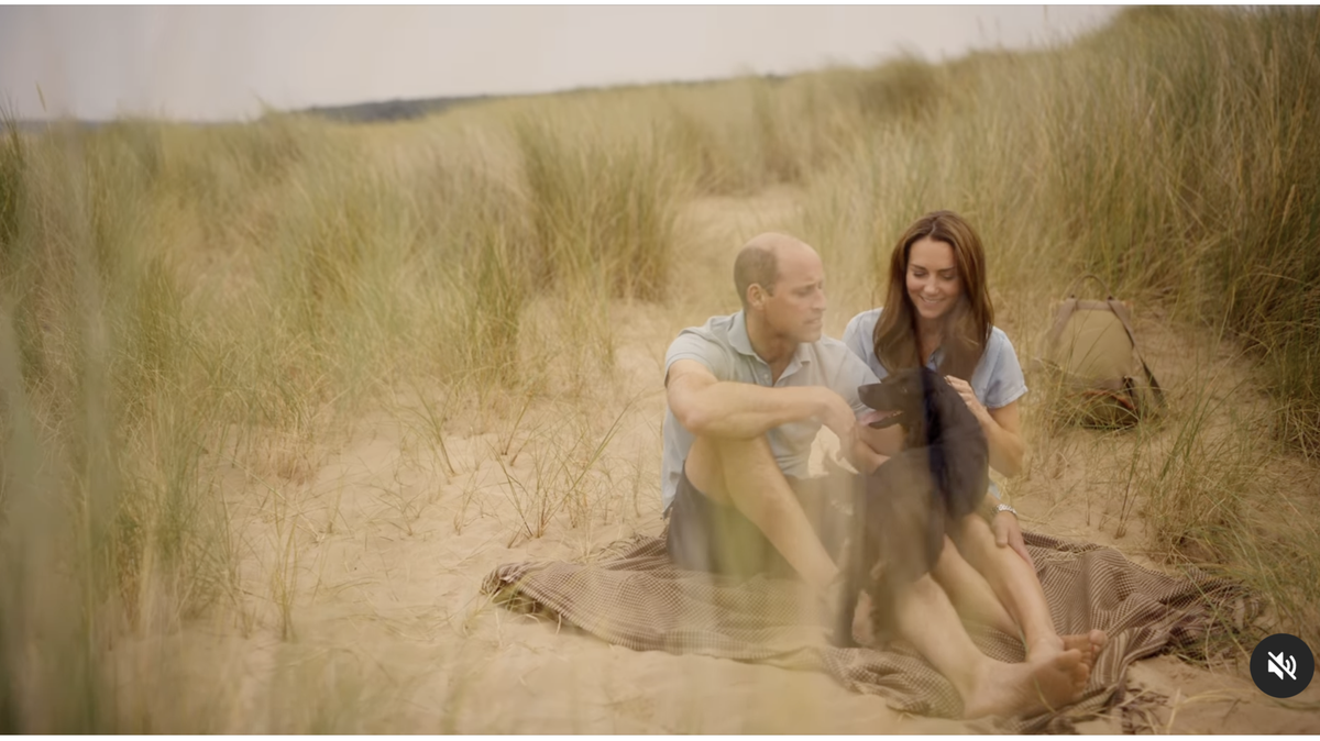 Kate Middleton and Prince William sit on the beach with their dog, Orla.