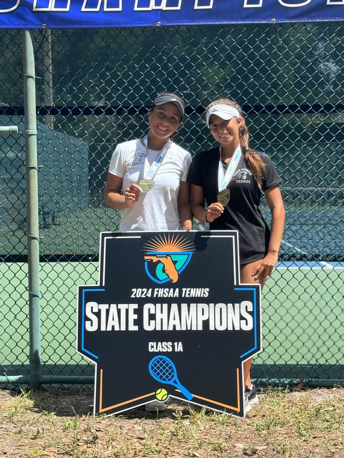 True North tennis players Daniela Chica (right) and Alba Martinez (left) celebrate after winning the Class 1A overall girls doubles championship on Friday in Casselberry, Fla.