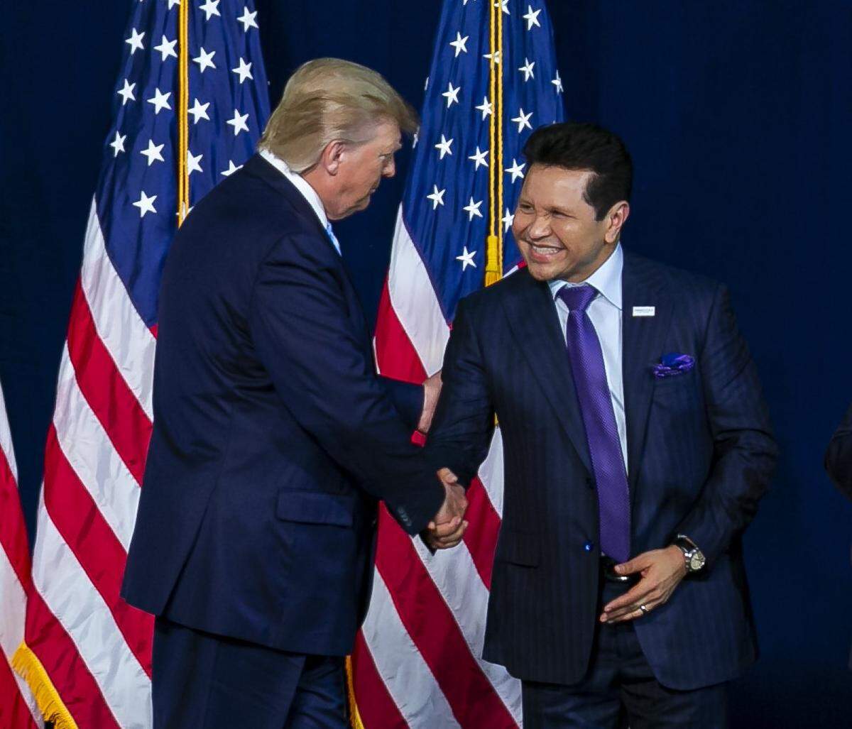 President Donald Trump shakes hands with Guillermo Maldonado, the head pastor of the King Jesus International Ministry, during the president’s “Evangelicals for Trump” rally on January 3, 2020.