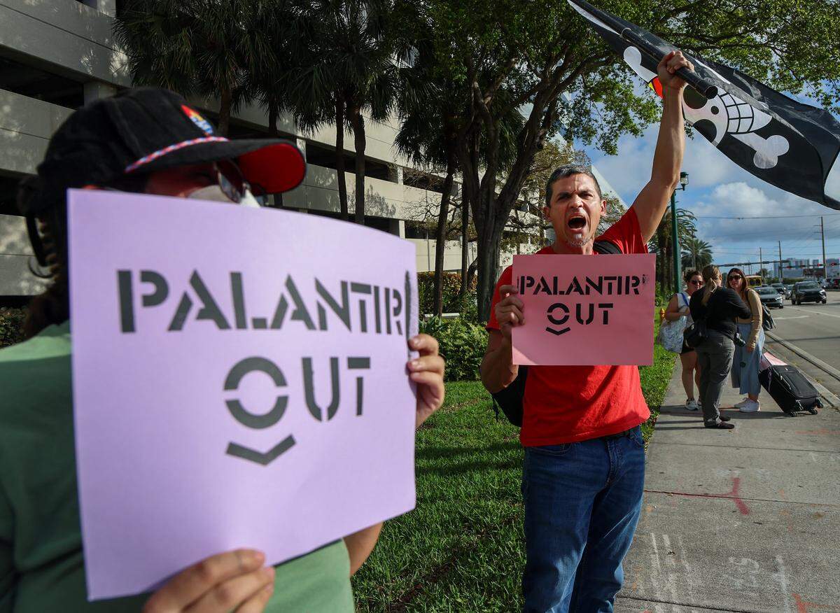 Protestor who goes by the name “Goose,” center, waves the “One Piece” pirate flag as a small group gathered around the mall entrance, wielding bright signs that conveyed messages calling for increased accountability and transparency from the tech giant on Tuesday, March 3, 2026 at the entrance of Aventura Mall in Aventura, Florida.