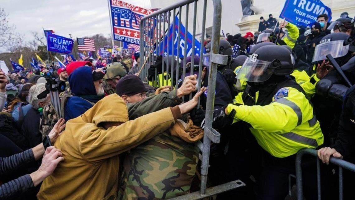 Rioters at the U.S. Capitol fight to break through a police barrier on Jan. 6, 2021.