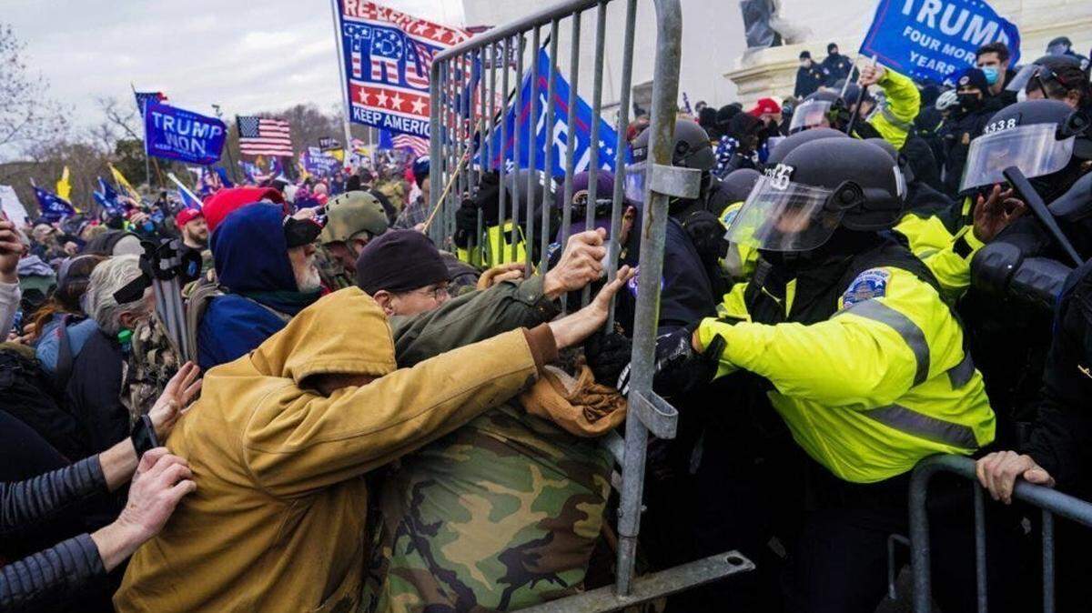 Rioters at the U.S. Capitol fight to break through a police barrier on Jan. 6, 2021. New UC Davis research reveals hope in reducing political violence, highlighting actionable steps for prevention and fostering societal peace in the United States.