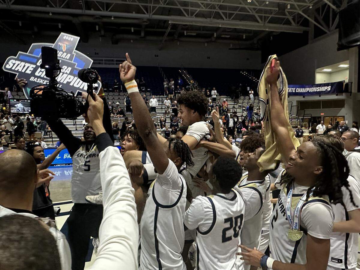 Calvary Christian guard Cayden Daughtry is carried on the shoulders of his teammates after the Eagles beat The Villages Charter for the Class 3A state boys’ basketball championship on Wednesday night at UNF Arena in Jacksonville, Fla.