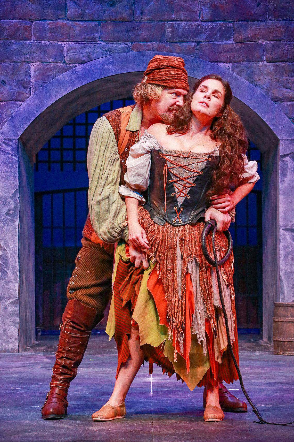 Michael Hunsaker as Captain of the Inquisition/Pedro has his grips on Aldonza, played by Gaby Tortoledo, in Actors’ Playhouse’s production of the musical “Man of La Mancha.”